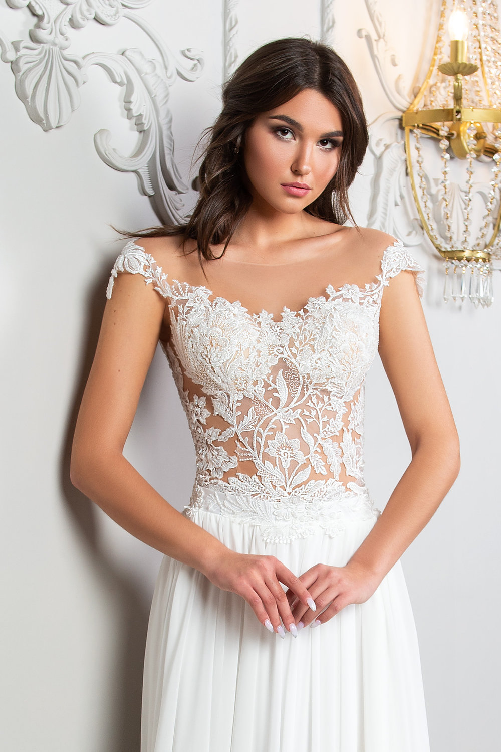 Romantisches A-Linien Brautkleid in Ivory mit floraler Spitze in Tattoooptik, transparenter Korsage, fließendem Chiffonrock, langer Schleppe und eleganter Knopfleiste am Rücken.